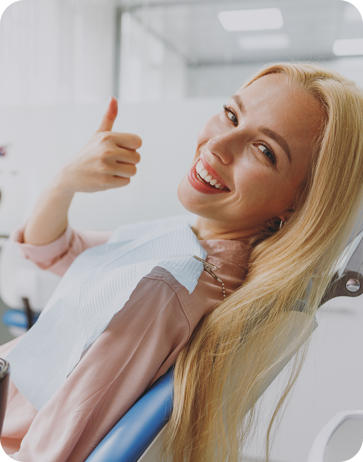 Happy dental patient giving a thumbs up